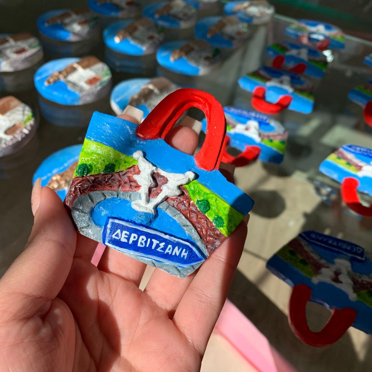 Decorative fridge magnets handcrafted with Dropulli motifs, made by a young artist